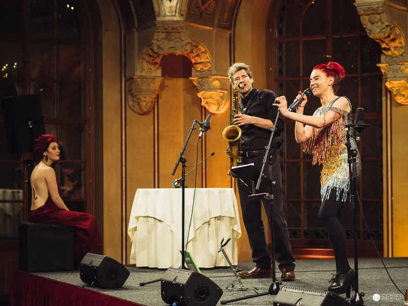 Vintage Jazz Performance with Saxophonist and Vocalist in Ornate Interior