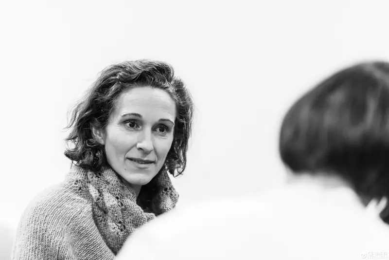 Melanie Laibl in Contemplative Half-Profile during Interview Session