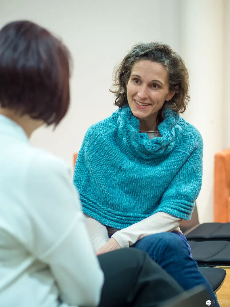 Two Women in Conversation, Seated in Contemplative Professional Consultation