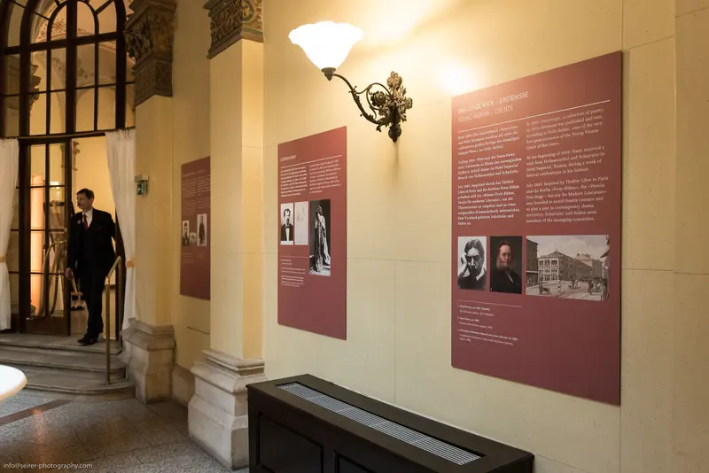 Museum Exhibition Interior Displaying Historical Biographical Panels and Archival Photographs