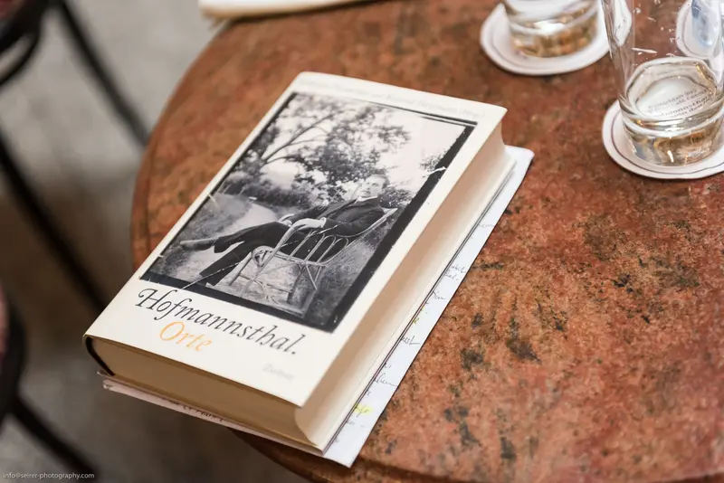 Black and White Image of Literary Book on Textured Marble Surface