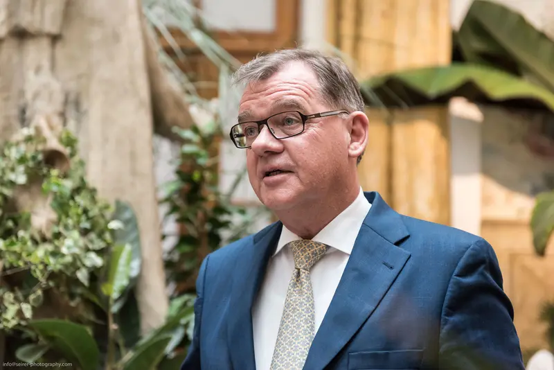 Middle-Aged Professional in Blue Suit and Patterned Tie at Indoor Location