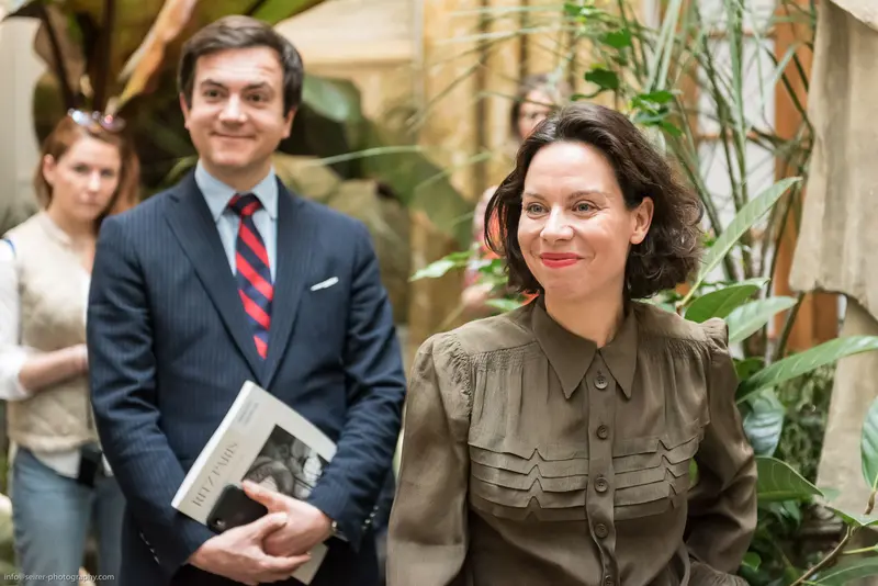 Mid-Century Professional Colleagues in Botanical Interior Setting