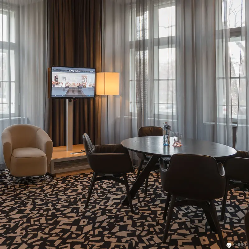 Contemporary Meeting Space with Modern Furnishings and Digital Display