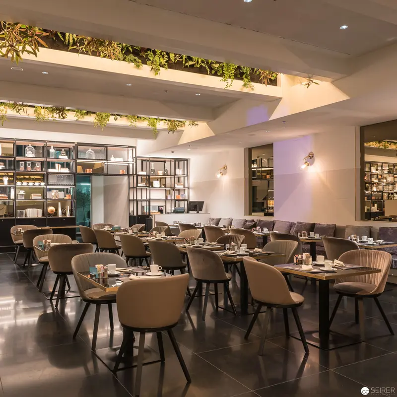 Contemporary Restaurant Interior with Verdant Overhead Botanical Installation