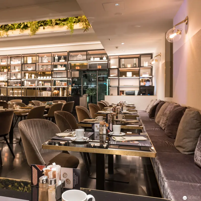 Contemporary Dining Space with Minimalist Design and Layered Shelving Composition