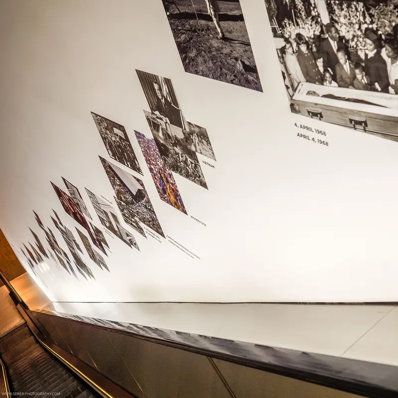 Documentary Photographic Display: Layered Black and White Images on Angled Surface