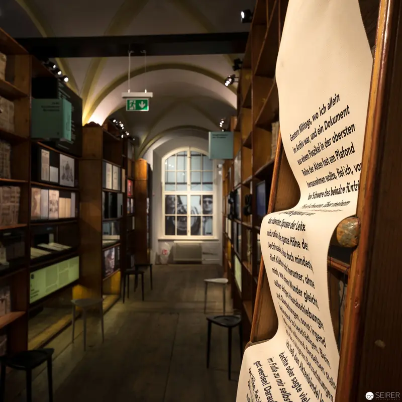 Archival Corridor with Illuminated Manuscript Displays and Vaulted Ceiling