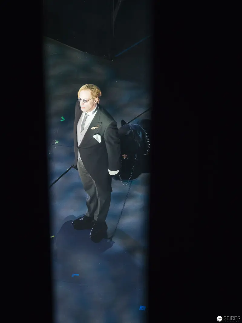 Solitary Performance in Dark Stage Setting during "Besuch der alten Dame"