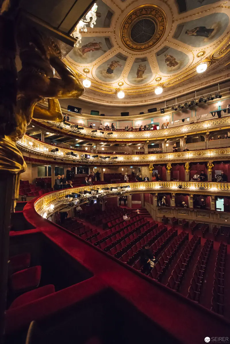 Ornate Interior of Historic Theater an der Wien with Red Velvet Auditorium