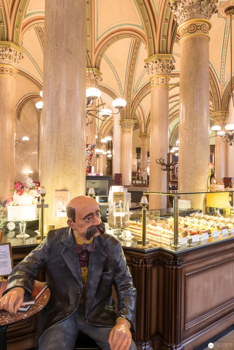 Contemplative Patron at Cafe Central's Elegant Baroque Interior