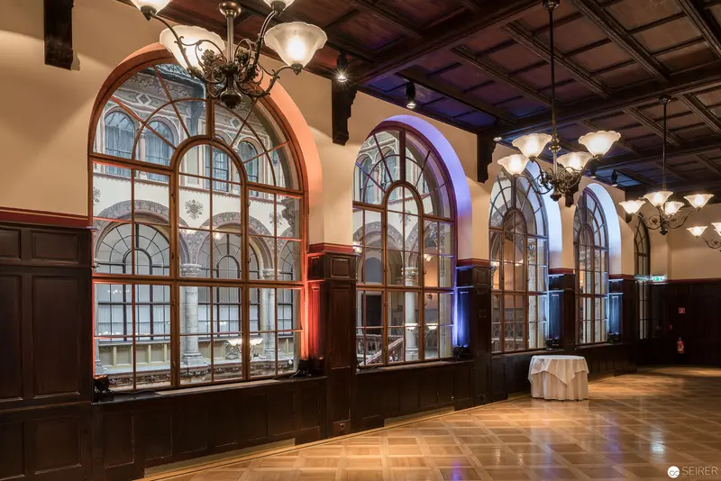 Architectural Interior of Cafe Central with Grand Arched Windows and Ornate Lighting
