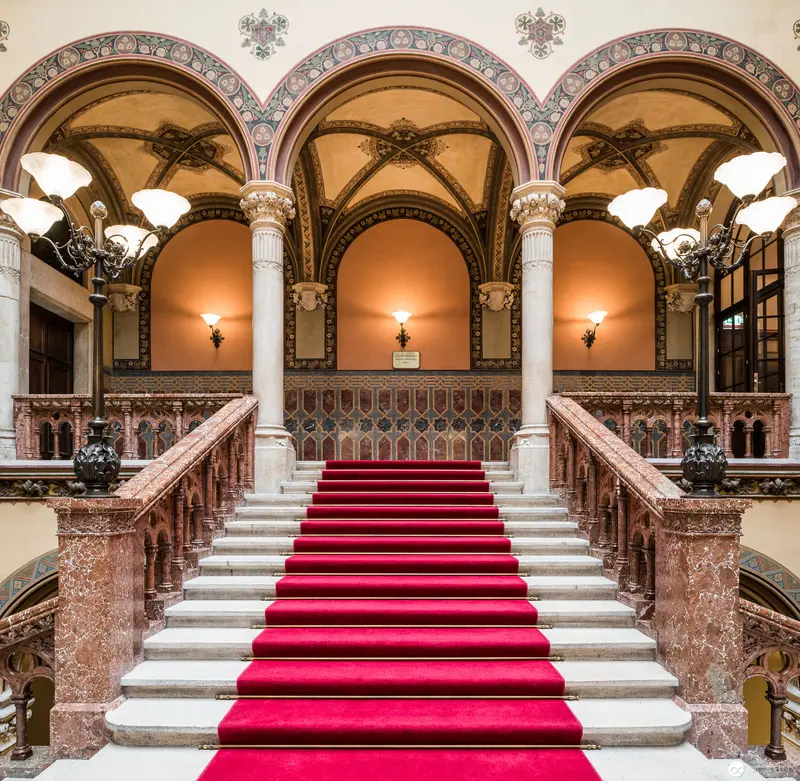 Palatial Interior with Ornate Red Carpet Staircase at Historic Viennese Venue