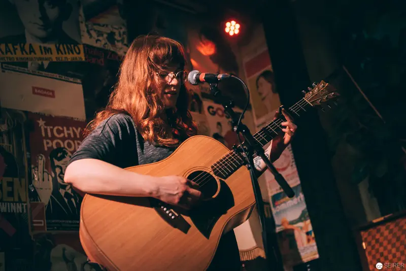 Acoustic Performer with Vintage Guitar at Intimate Musical Venue