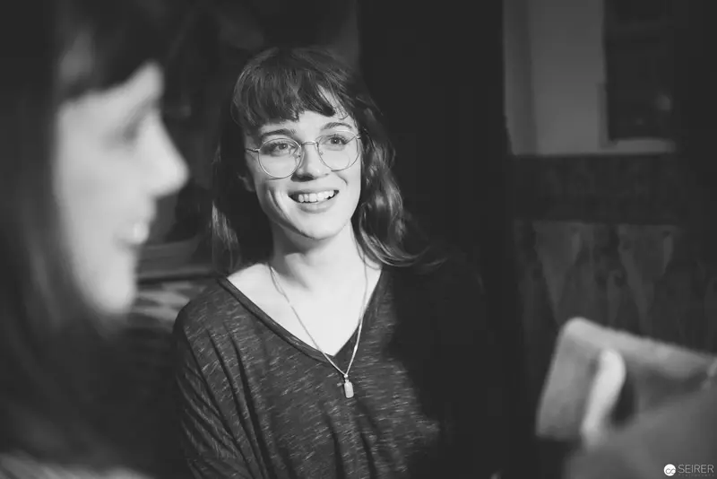 Smiling Woman with Glasses in Black and White Portrait