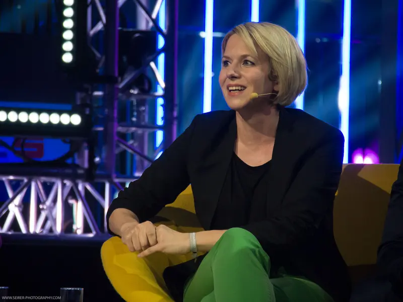 Speaker Engaging Audience at 4GameChangers Festival in Dynamic Stage Setting