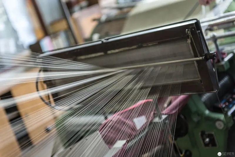 Industrial Textile Loom Showing Intricate Thread Tension and Weaving Mechanics