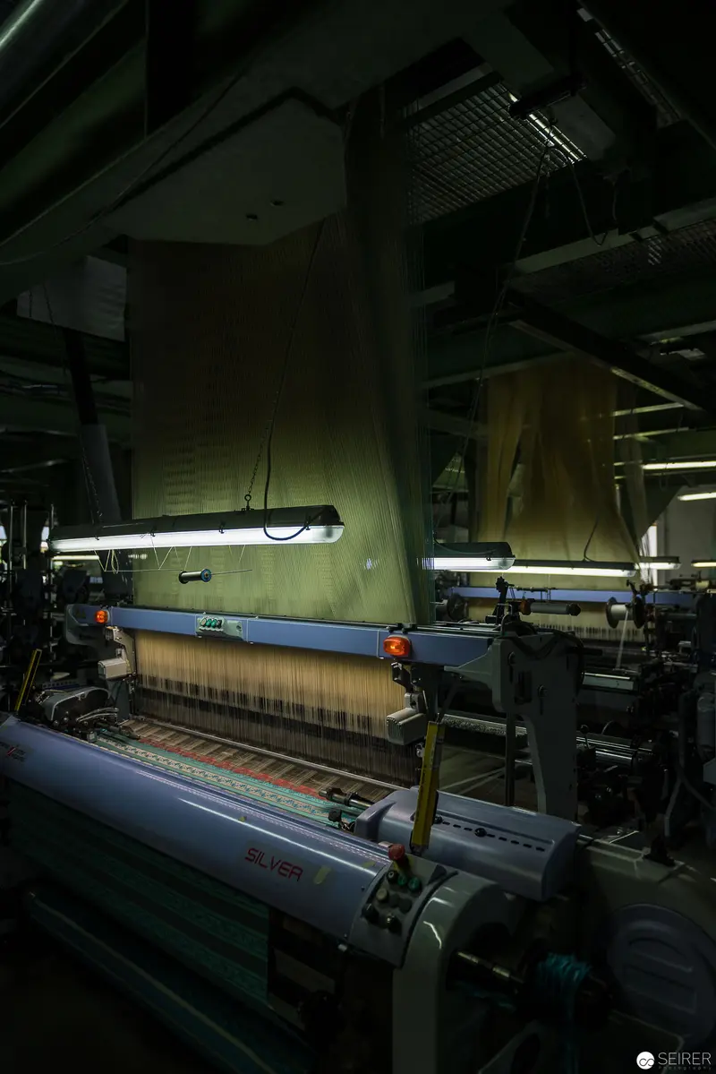 Industrial Textile Loom in Moody Green-Tinted Manufacturing Environment