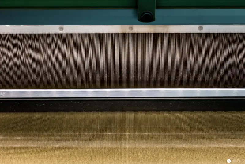 Textural Close-Up of Industrial Weaving Machinery Fabric Layers