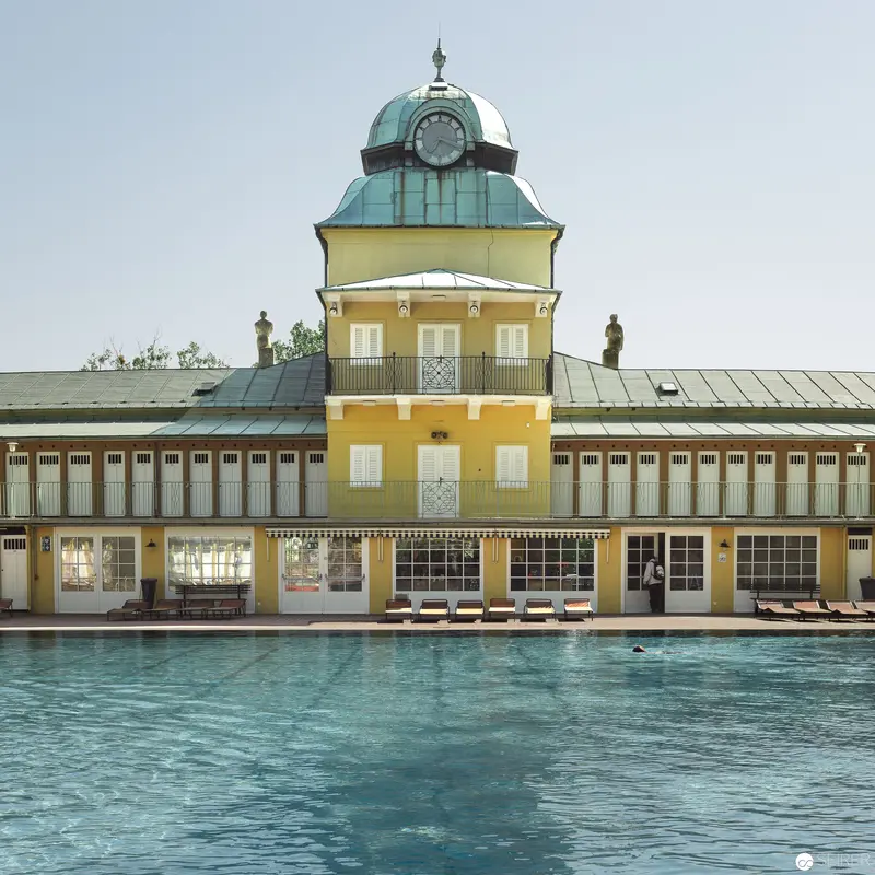 Yellow-Ochre Bathhouse with Turquoise Dome Overlooking Thermal Pool at Bad Vöslau