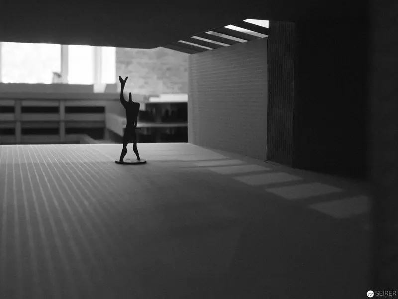Minimalist Figure in Abstract Architectural Space with Dramatic Light and Shadow