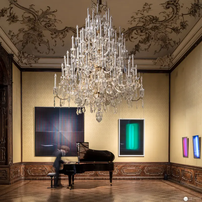 Grand Piano Beneath Opulent Crystal Chandelier in Baroque Salon