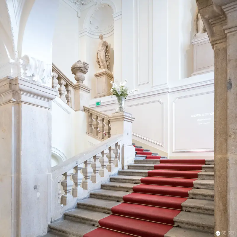 Baroque Staircase with Red Carpet in Elegant White Interior