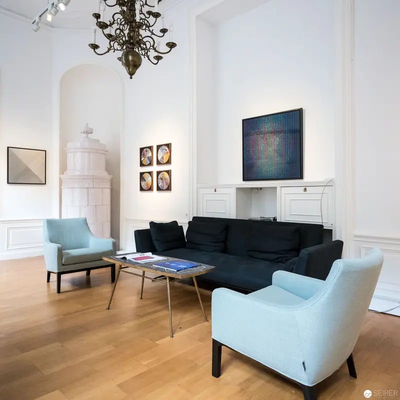 Contemporary Art Gallery Interior with Minimalist Furnishings and Decorative Chandelier