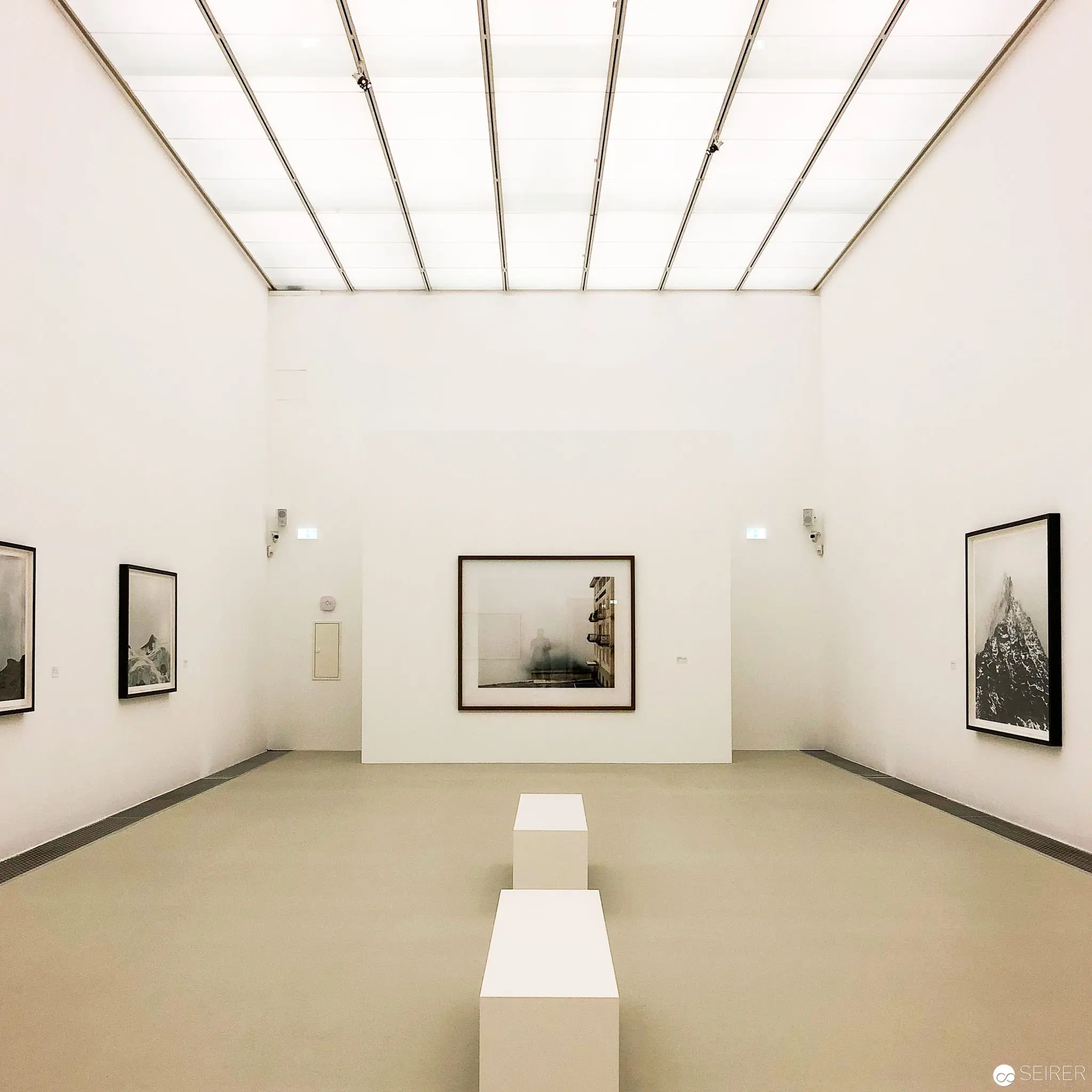Minimalist Gallery Space with Monochromatic Photographic Exhibition