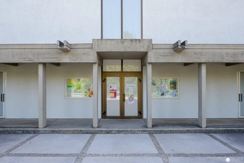Minimalist Entrance of Concrete Municipal Building with Informational Displays
