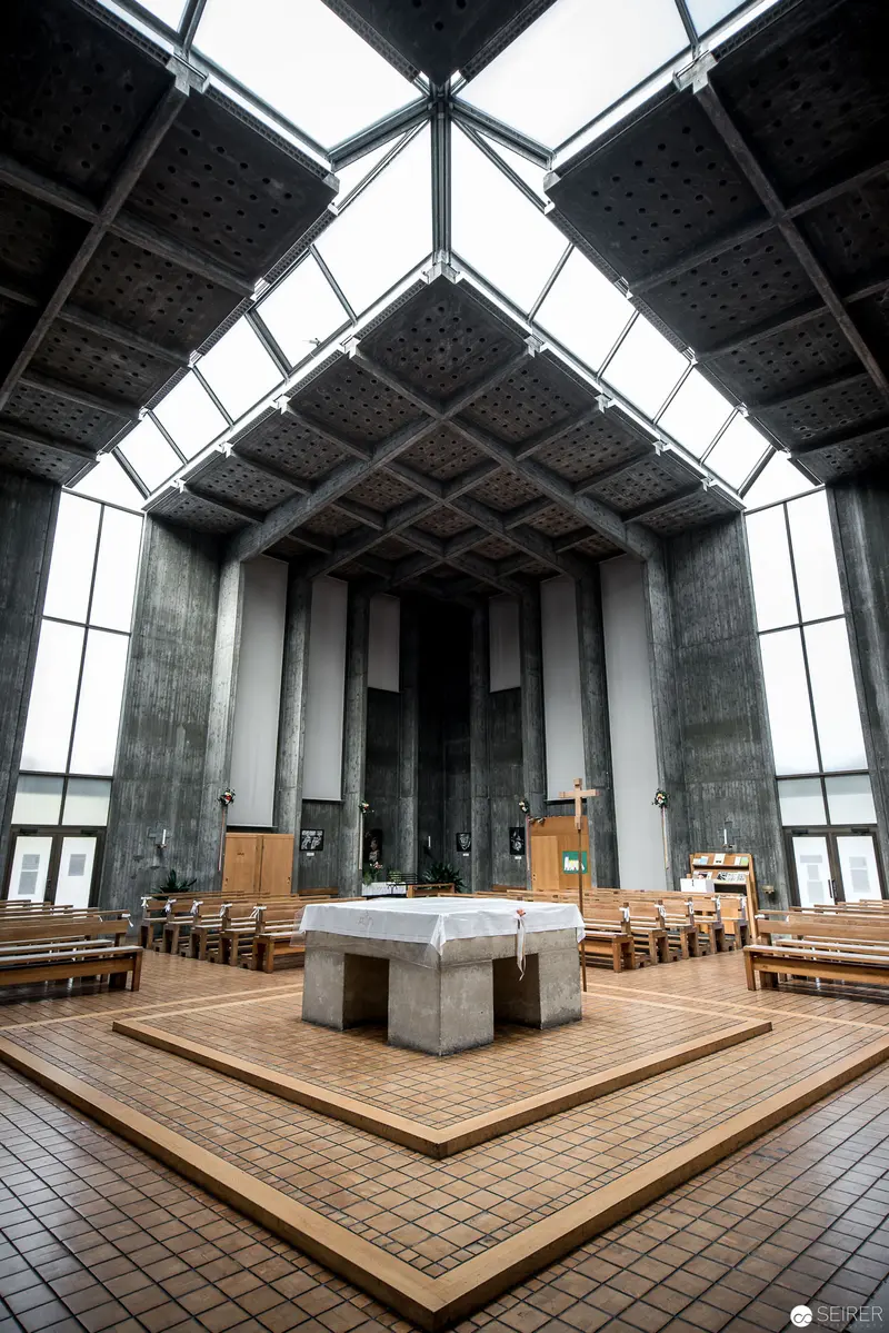 Modern Concrete Church Interior with Geometric Skylights and Central Altar