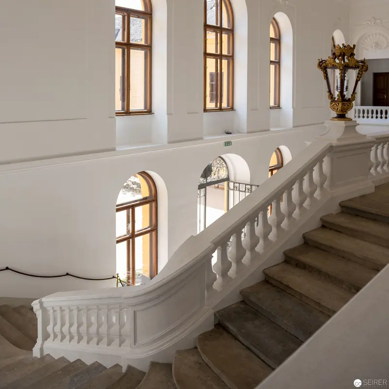 Elegant White Staircase with Arched Windows in Classical Interior Architecture