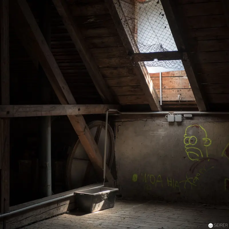 Abandoned Attic Interior with Skylight and Graffiti at Schloss Eckartsau