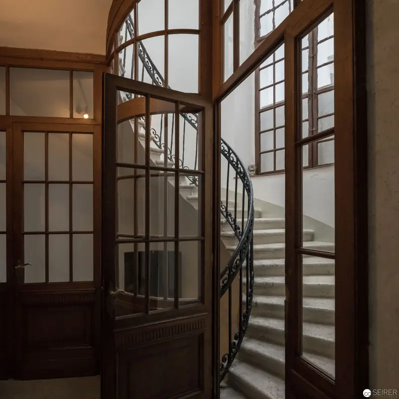 Art Nouveau Staircase with Curved Iron Railing in Architectural Interior