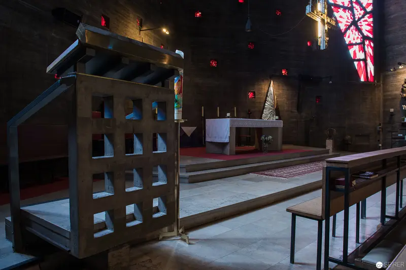 Interior View of Pfarre zum guten Hirten with Liturgical Furnishings and Stained Glass