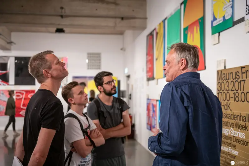 Exhibition View: Visitors Discussing Graphic Design at 100 Beste Plakate 17, MAK Vienna