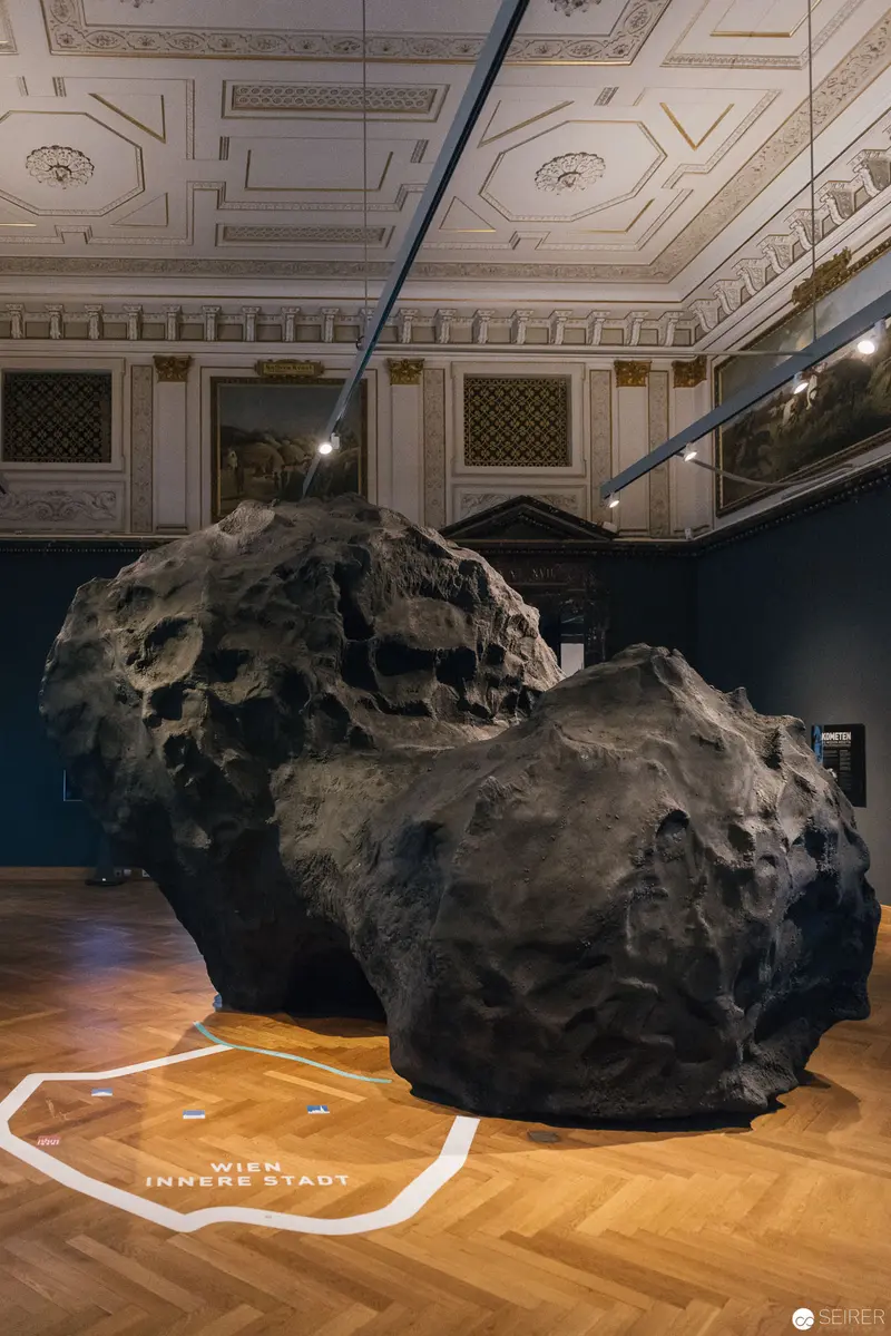 Massive Dark Meteorite Displayed in Ornate Naturhistorisches Museum Wien Exhibition Space