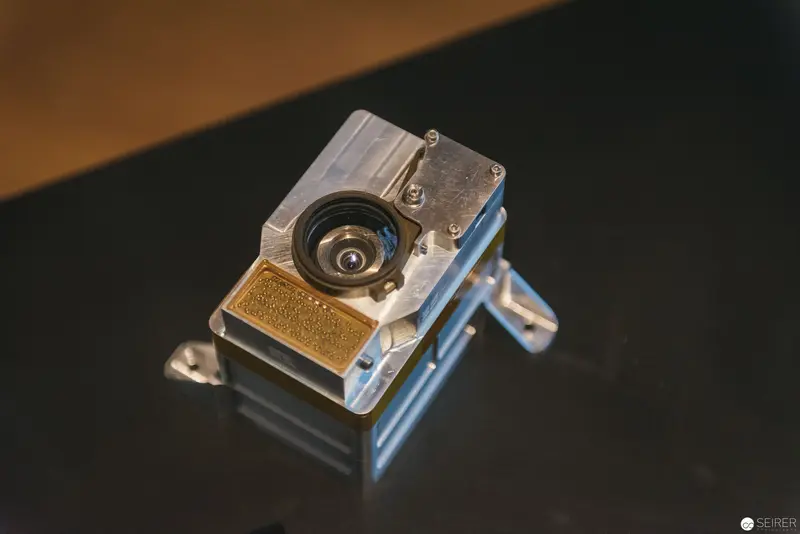 Precision Machined Camera Component on Dark Reflective Surface
