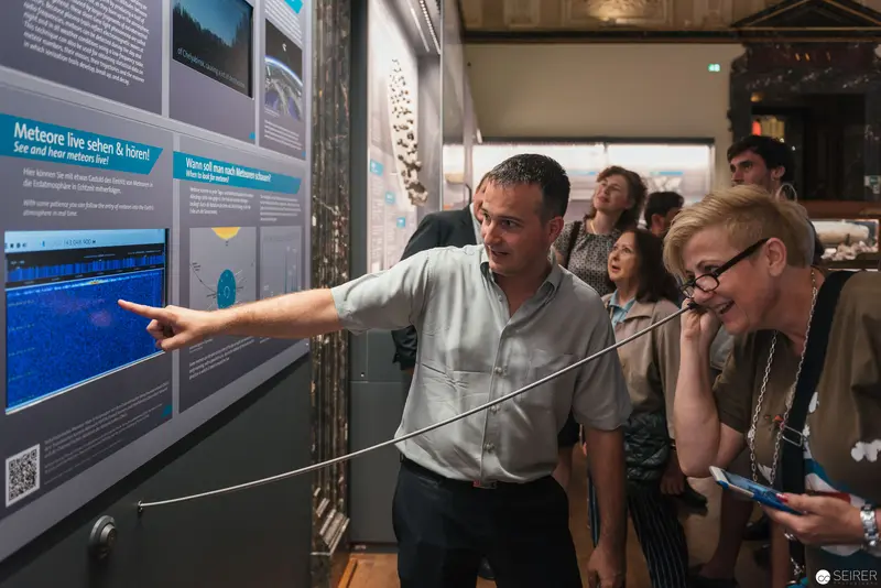 Asteroid Day Exhibition Visitors Exploring Interactive Display at Natural History Museum Vienna