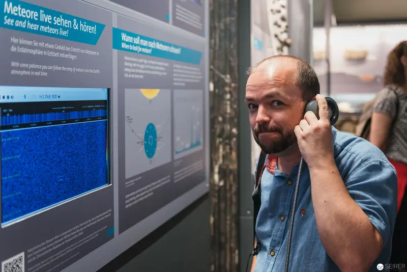 Asteroid Day Exhibition Visitor Listening at Naturhistorisches Museum Wien