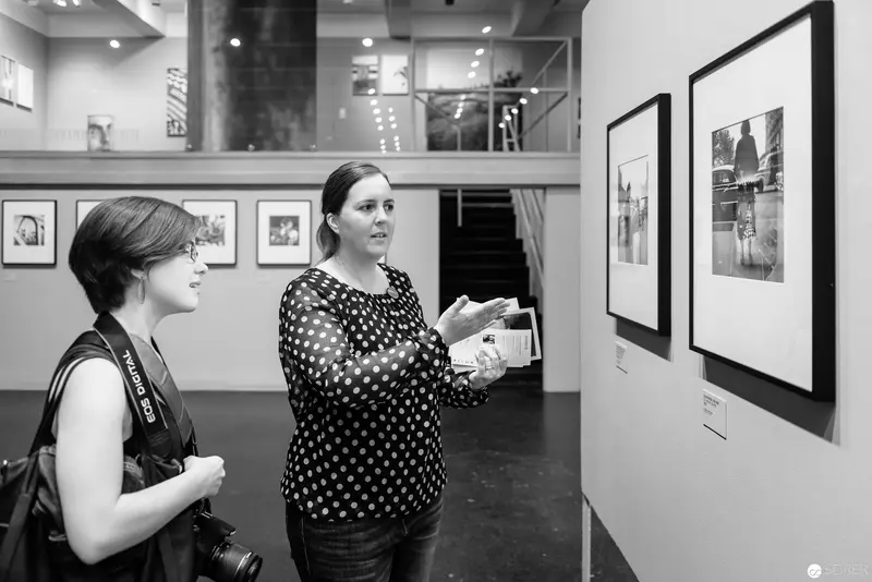 Gallery Conversation: Two Women Discussing Photographic Exhibition