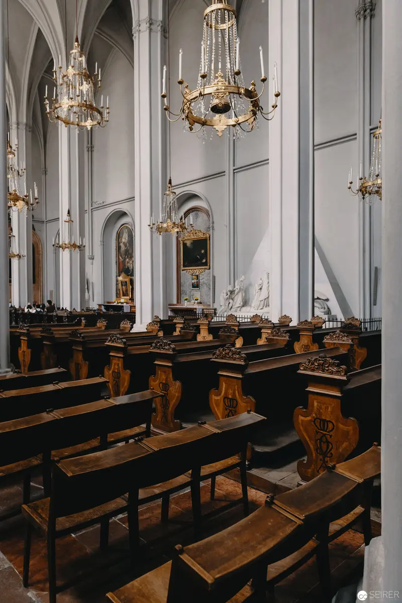 Gothic Interior with Wooden Choir Stalls and Elaborate Chandeliers