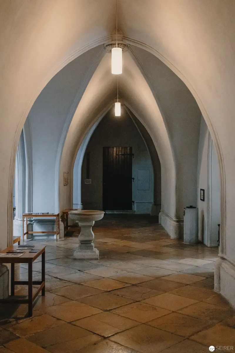 Gothic Arched Interior with Stone Floor and Pendant Lighting