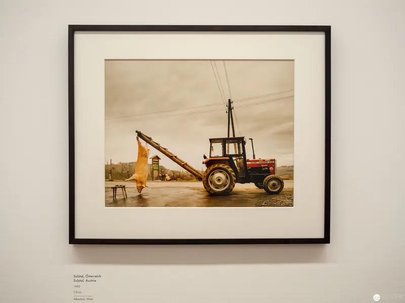 Rural Agricultural Scene with Tractor and Enigmatic Figure in Sepia Tones