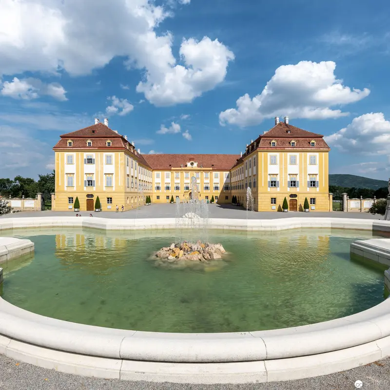 Baroque Palace Complex with Symmetrical Yellow Facade and Central Fountain
