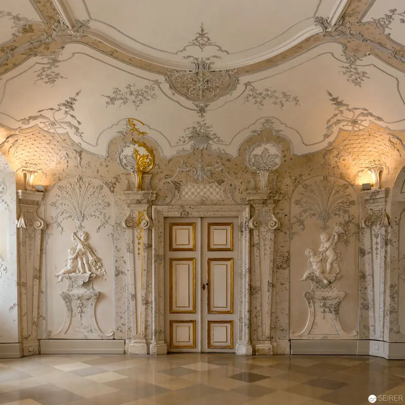 Baroque Interior with Ornate Plasterwork and Sculpted Figures at Elaborate Palatial Salon