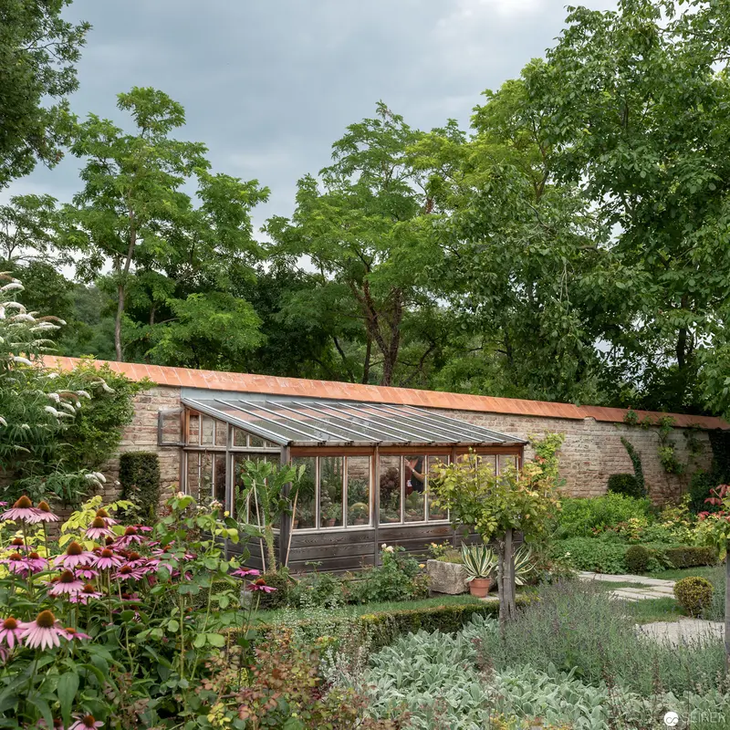 Victorian Glass Greenhouse within Lush Walled Garden Landscape