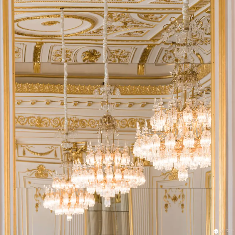 Ornate Baroque Interior with Elegant Crystal Chandeliers and Gilded Architectural Detailing