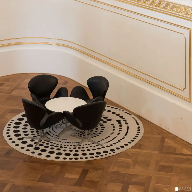 Modern Black Floral-Inspired Chair Arrangement on Geometric Floor Rug