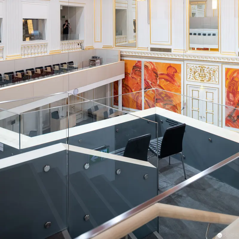 Architectural Interior with Orange Mural and Glass Partitions in Modern Office Space